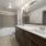 bathroom with a large mirror and walk-in shower