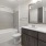 bathroom with a large mirror and tub