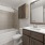 bathroom with a large mirror and walk-in shower