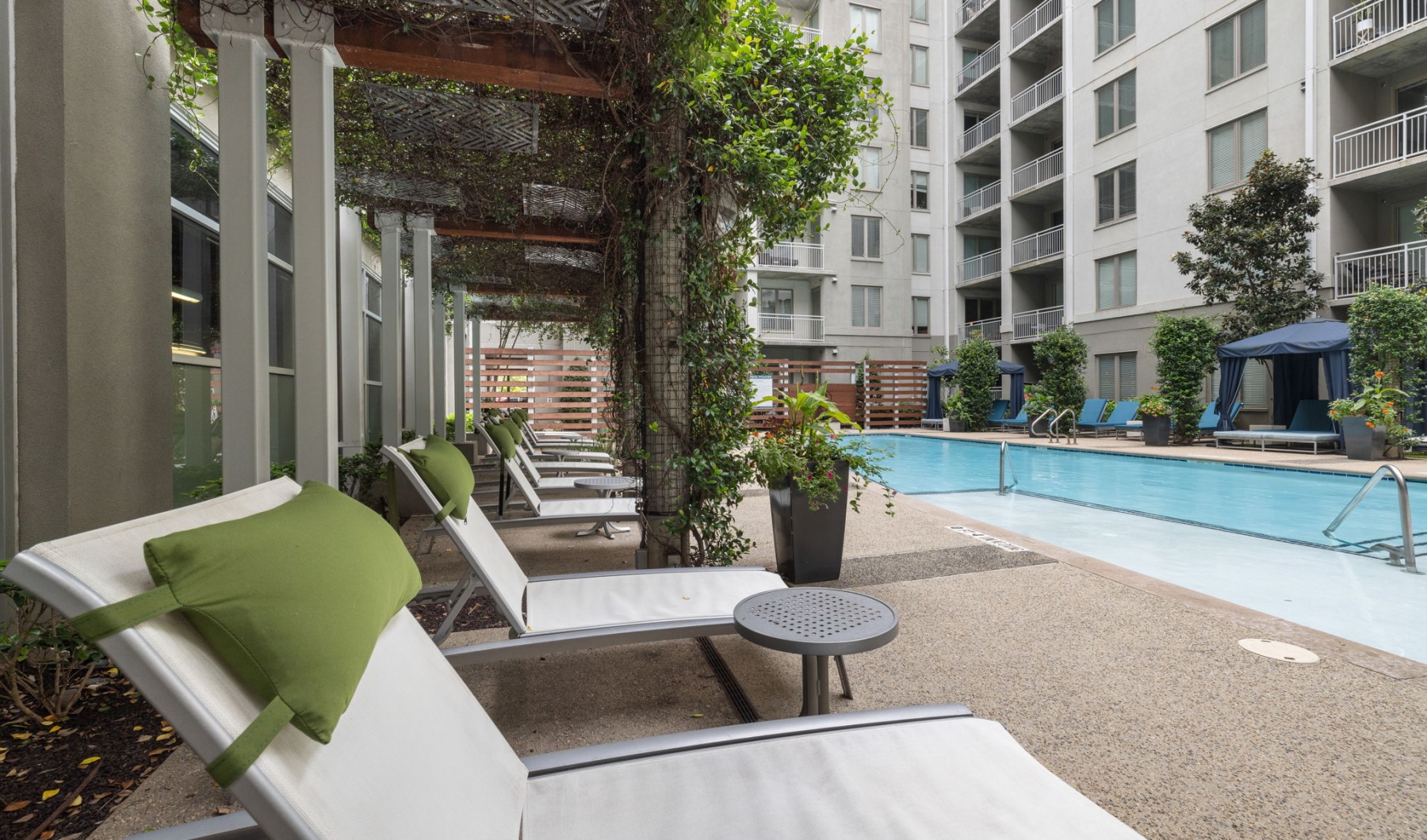 patio chairs on pool deck overlooking building