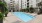 pool with lounge chairs and plants